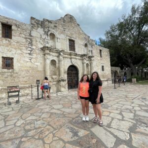 Traveling Trio Family taking a picture by Alamo in Texas