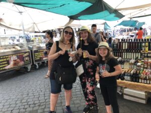 Gluten-Free Traveling Trio Family in Rome trying yummy fruit fresh from the market