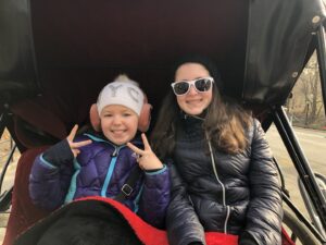 Gluten-Free Traveling Trio Family in New York city exploring Central Park in a carriage