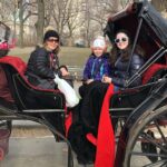 Gluten-Free Traveling Trio Family in New York city exploring Central Park in a carriage