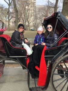 Gluten-Free Traveling Trio Family in New York city exploring Central Park in a carriage