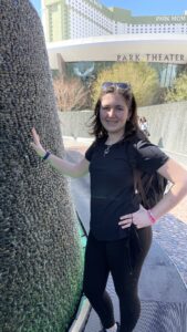 Gluten-free Traveling Family Trio taking picture by a lit-up waterfall in Las Vegas, Nevada