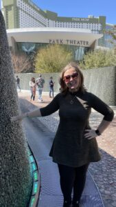 Gluten-free Traveling Family Trio taking picture by a lit-up waterfall in Las Vegas, Nevada