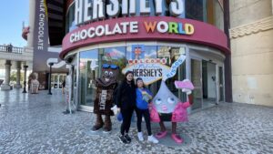 Gluten-free Traveling Family Trio taking picture by the Hershey's store in Las Vegas, Nevada