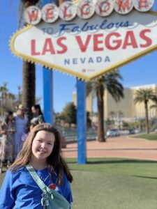 Gluten-free Traveling Family Trio taking picture by the Las Vegas sign in Las Vegas, Nevada