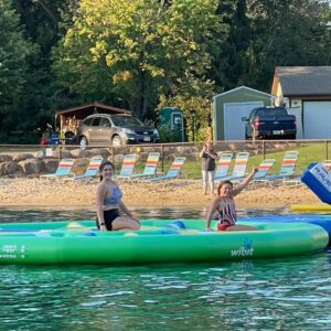 Gluten-free Traveling Trio Family using inflatables in the lake in Baraboo, Wisconsin