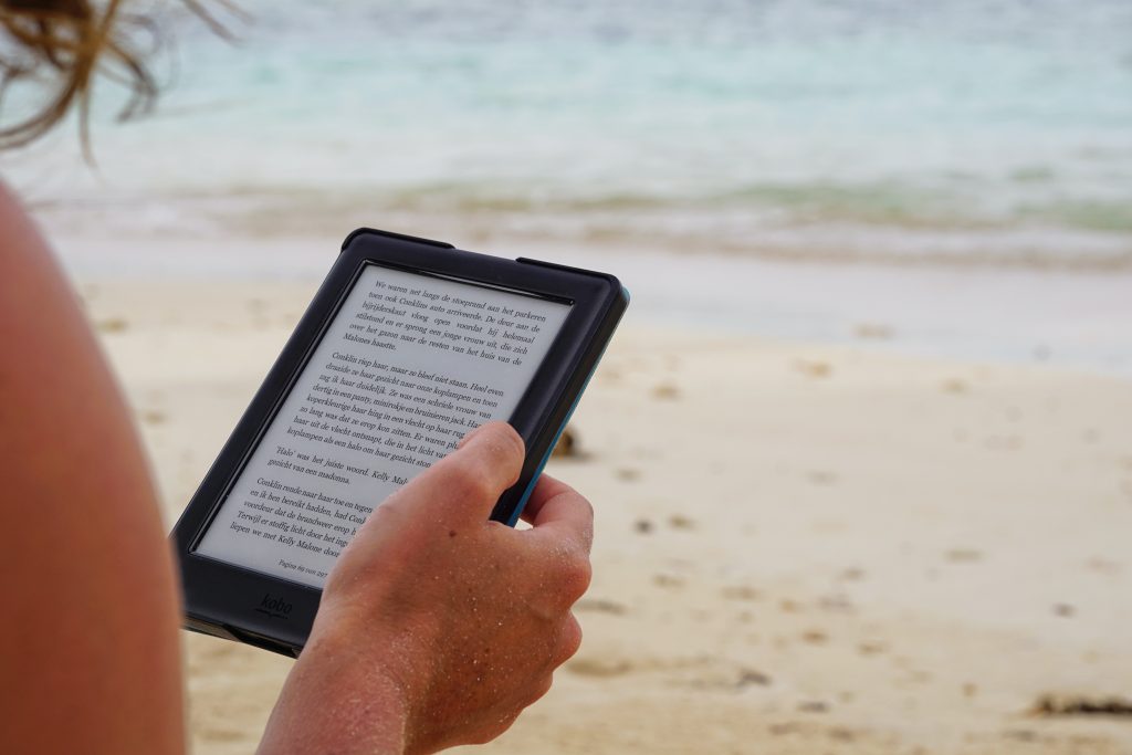 Reading Kindle on a beach