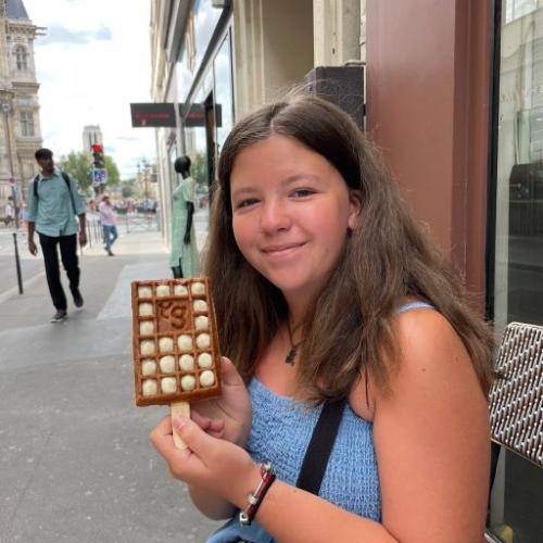 Enjoying waffle on a stick in Paris, France.